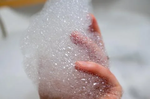 Tactile moment of soft bubbles and skincare enthusiasm vividly documented Stock Photos