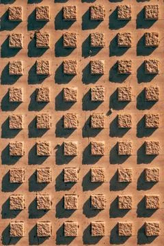Tactile paving surface with a geometric grid pattern for visually impaired .. Stock Photos