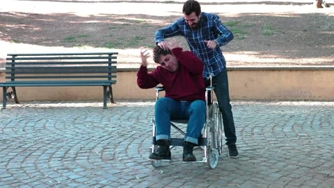 Tactlessness, poor sensitivity - young man annoys his friends with disability Stock-Footage 166172336