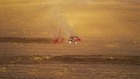 Tactor with disk harrow on plowing field. Sowing seed. Seeding Stock Footage 161418875