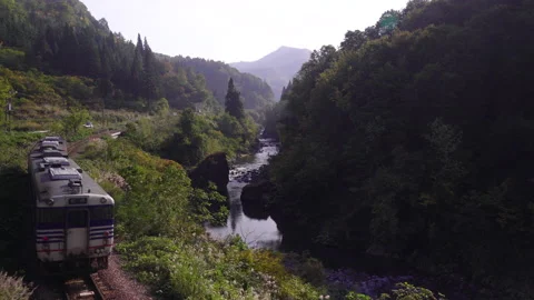 Tadami line, train moving along the river Video stock 162222367