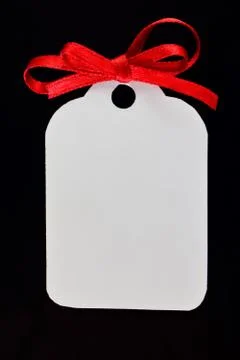 The tag is white on a black background with red bow. Stock Photos