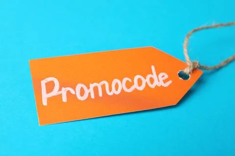Tag with words Promo Code on light blue background, closeup Foto stock
