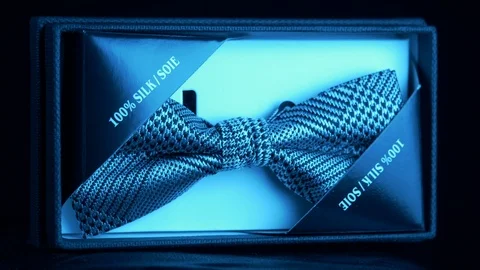 Tagged luxurious patterned silk bow tie in retail box- diamond blue light 4k Stock Footage 98403926
