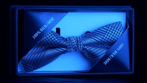 Tagged luxurious patterned silk bow tie in retail box - sapphire light 4k Stock Footage 98404729