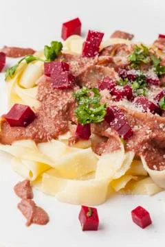Tagliatelle with beet root sauce Stock Photos