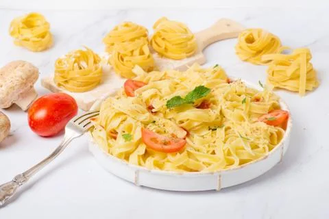 Tagliatelle pasta with tomatoes and mushrooms Stock Photos