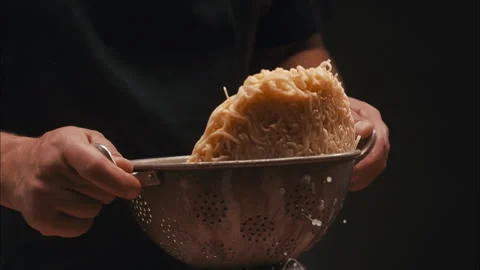 Tagliatelle in a strainer in slow motion Stock Footage 254846048