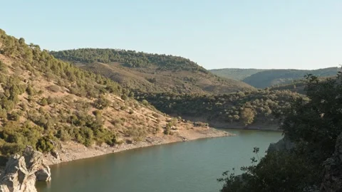 Tagus river flowing peacefully through green rocky hills in Monfrague Nation Stock Footage 337907125