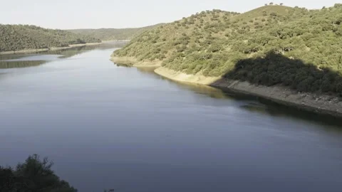 Tagus river flows peacefully through green hills in Monfrague National Park Stock Footage 337906108