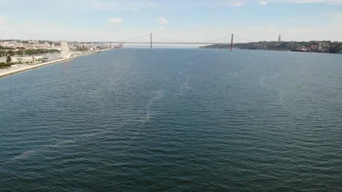 Tagus river Lisboa. 25 de Abril Bridge and Christ the King monument in Portugal Stock Footage 247261887