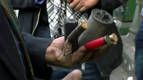 Tahrir square, Old man shows bullet cartridge and smoke grenade at the people Stock Footage