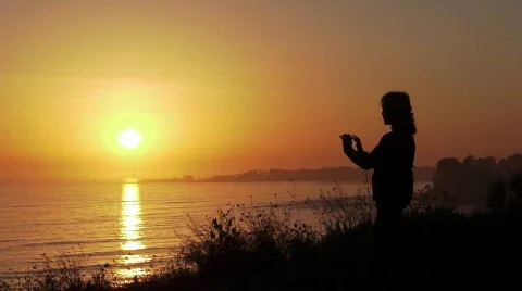 Tai Chi on the Ocean Cliffs at Sunset Stock Footage 629876