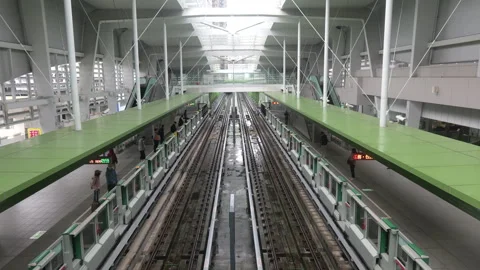 Taichung MRT Green Line train arrival at elevated Zhongqing Station platform Stock Footage 334577052