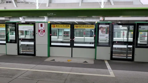 Taichung MRT platform screen doors synchronized with train doors Zhongqing Stock Footage 334582732
