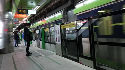 Taichung MRT platform with screen doors and arriving train passenger waiting Stock Footage 334582746