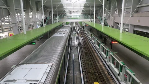 Taichung MRT train departure and arrival from elevated platform Wenxin Stock Footage 334577531
