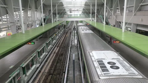 Taichung MRT train departure from elevated Zhongqing Station dual track platform Stock Footage 334582715