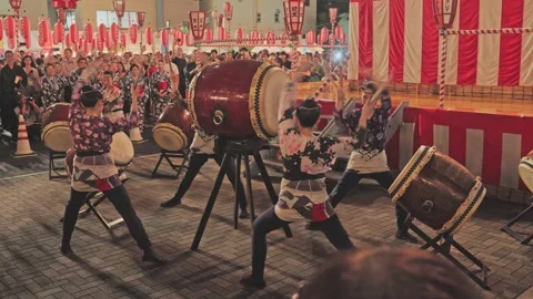 Taiko Drum Ensemble Performing in Unison Before a Festival Crowd Stock Footage 345840824