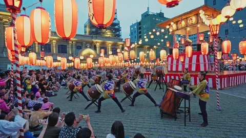 Taiko Drum Team Performing at Dusk Surrounded by Seated Audience Stock Footage 345825376