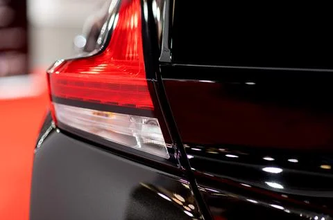 Tail light of nice and new black sport suv car in modern garage. Stock Photos