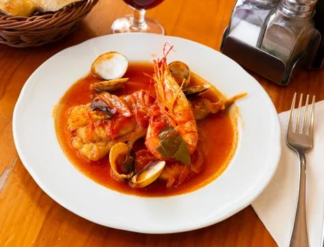 Tail of monkfish with shellfish, prawns Stock Photos