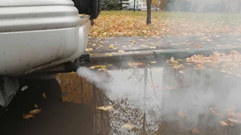 Tail pipe of old car from which cloud of exhaust comes out. Air pollution in Stock Footage 125209830