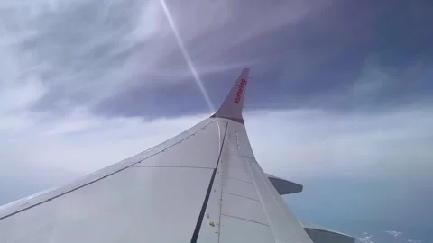 The tail of a Sunwing airplane with clouds in the background Stock Footage 271319207