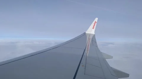 The tail of a Sunwing airplane with clouds in the background Stock Footage 271319271