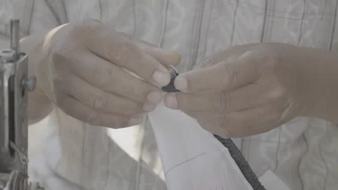 Tailor Adding Decorative Details to Clothing 10bit slog3 Stock Footage 345619726