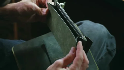 Tailor assembles women wallet of leather details in workshop Stock Footage 296749766