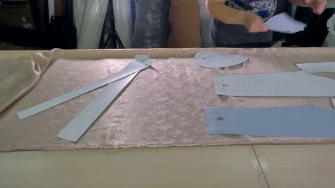 A tailor choosing pattern placement on cloth. Stock Footage 77340650