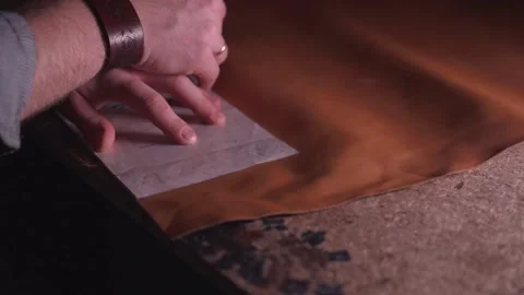 The tailor circles the blank on the fabric Stock Footage 145426750