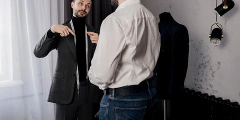 Tailor communicates with a client Stock Photos