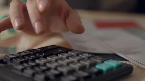 Tailor counting on calculator at work place. Businessman Doing Calculations Stock Footage 109328574