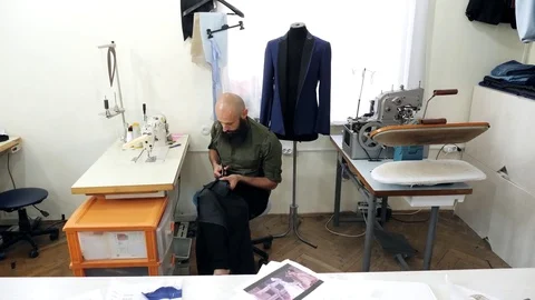 Tailor is cut fabric to make a suit Stock Footage 80732297