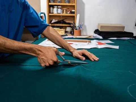 Tailor Cutting Fabric With Large Professional Scissors Stock Photos