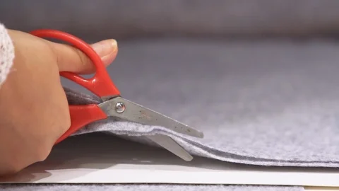 Tailor is cutting fabric with scissors Stock Footage 99036363