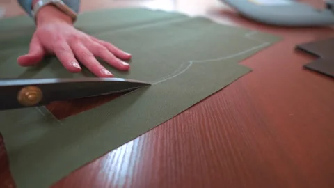 Tailor cutting fabric with scissors Stock Footage 320869046