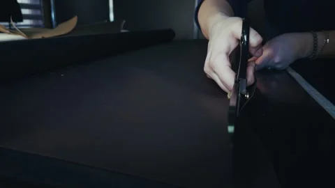 Tailor is Cutting Fabric With Scissors Stock Footage 329136417