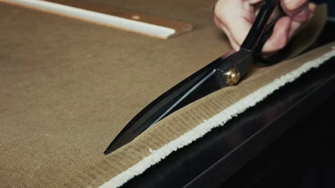 Tailor is Cutting Fabric With Scissors Stock Footage 329138792