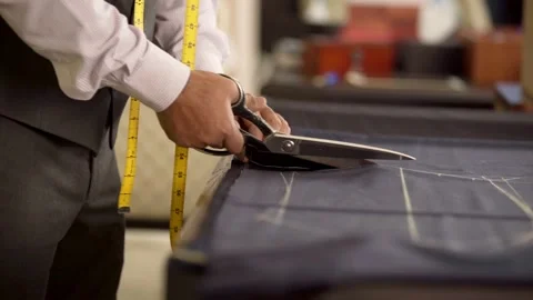 Tailor cutting fabric using fabric scissors Stock Footage 163185983