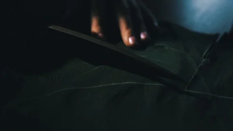 Tailor cutting fabric using large scissors or shears as he follows the chalk Stock Footage 86450163
