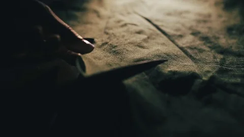 Tailor cutting fabric using large scissors or shears as he follows the chalk Video stock 86450170