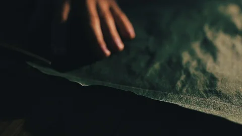 Tailor cutting fabric using large scissors or shears as he follows the chalk Video stock 86450190