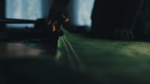 Tailor cutting fabric using large scissors or shears as he follows the chalk Video stock 86450200