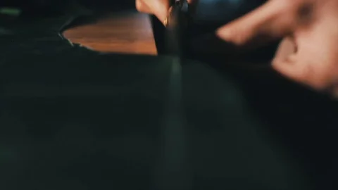 Tailor cutting fabric using large scissors or shears as he follows the chalk Stock-Footage 86450235