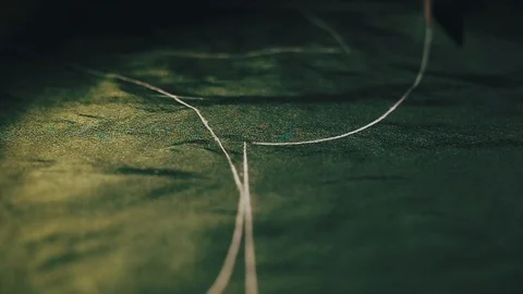 Tailor cutting fabric using large scissors or shears as he follows the chalk Stock-Footage 86450250