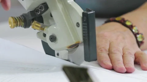 Tailor cutting the patterns with electric saw Stock Footage 62350703