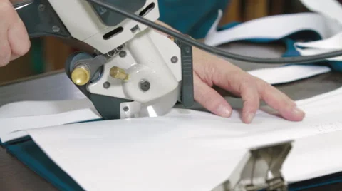 Tailor cutting the patterns with electric saw Stock Footage 62353535